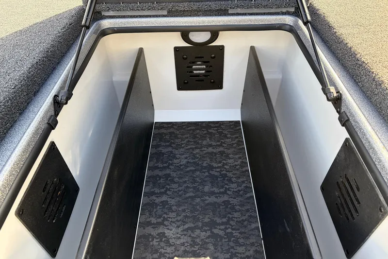 Slide: The Image of 2026 Nitro Z19 XL Pro boat storage compartment with black interior and textured flooring. - 26