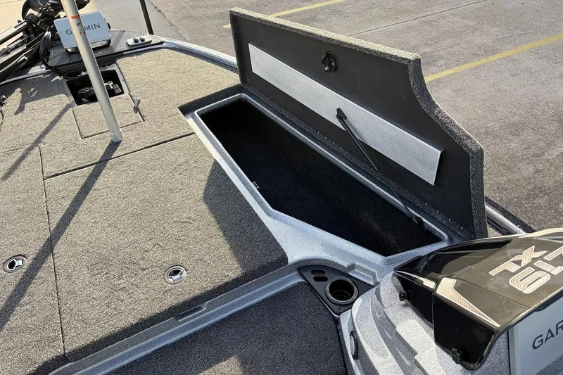 Slide: The Image of 2026 Nitro Z19 XL Pro boat deck with open storage compartment and Garmin equipment. - 27