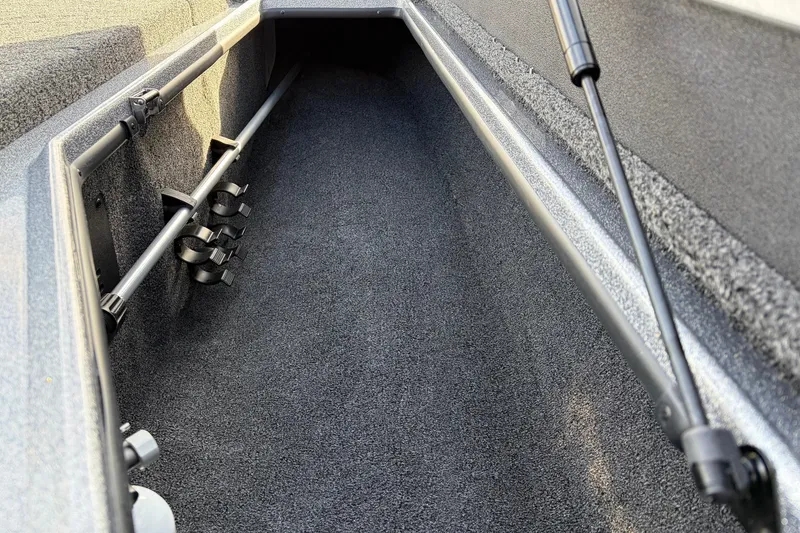 Slide: The Image of Interior storage compartment of 2026 Nitro Z19 XL Pro boat, featuring rod holders. - 29