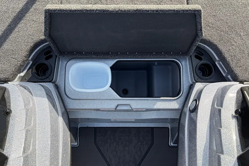 Slide: The Image of 2026 Nitro Z19 XL Pro boat storage compartment with open lid and cup holders. - 32