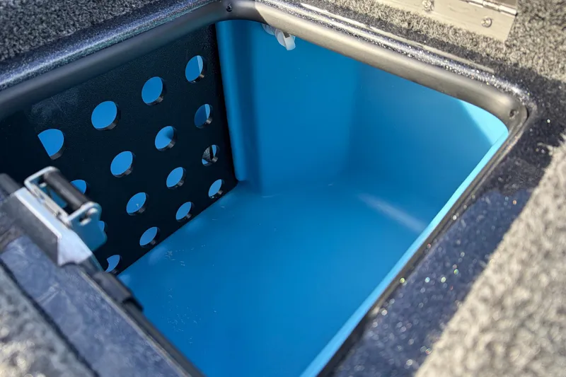 Slide: The Image of 2026 Nitro Z19 XL Pro boat storage compartment with blue interior and perforated panel. - 51