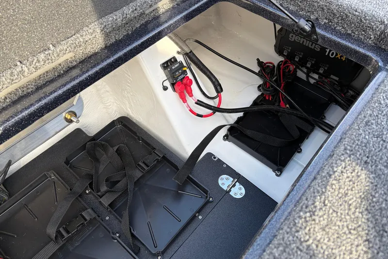 Slide: The Image of Battery compartment of 2026 Nitro Z19 XL Pro boat with wiring and charger. - 63