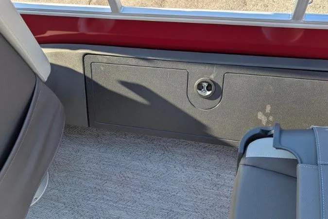 Slide: The Image of Interior of 2026 Sun Tracker Fishin' Barge 22 DLX with seating and storage compartment. - 5