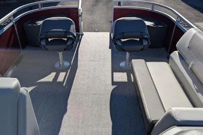 Slide: The Image of 2026 Sun Tracker Fishin' Barge 22 DLX interior with seating and fishing chairs. - 7