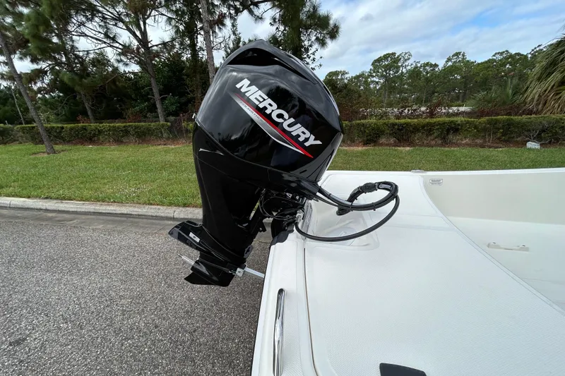 Slide: The Image of 2026 Mako Pro Skiff 15 CC with Mercury outboard motor on a paved surface. - 9