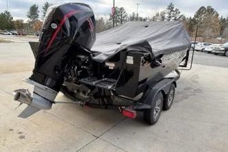 Slide: The Image of 2024 Tracker Targa V-19 WT boat on trailer, covered, parked outdoors. - 3