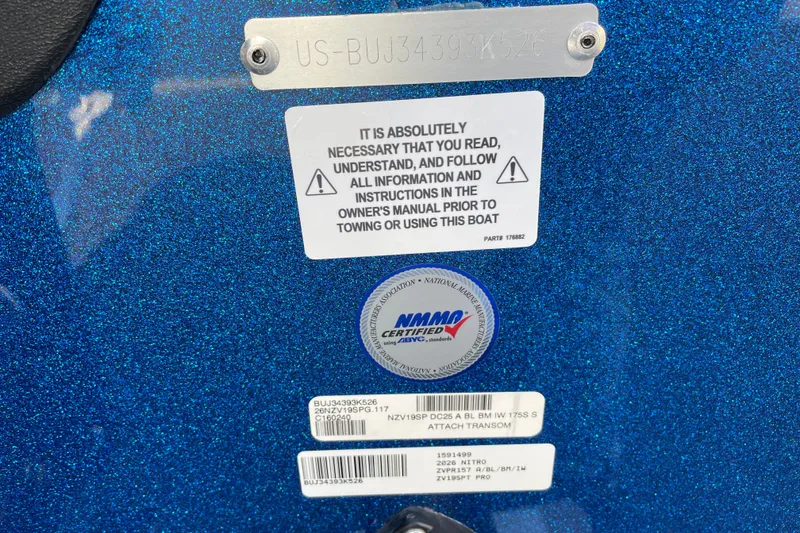 Slide: The Image of 2026 Nitro ZV19 Sport Pro boat warning and certification labels on blue metallic surface. - 65