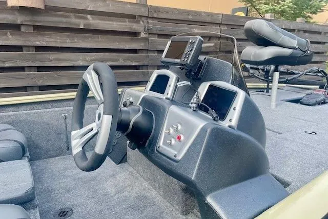 Slide: The Image of 2026 Tracker Pro Team 195 boat interior with steering wheel and control panel. - 3