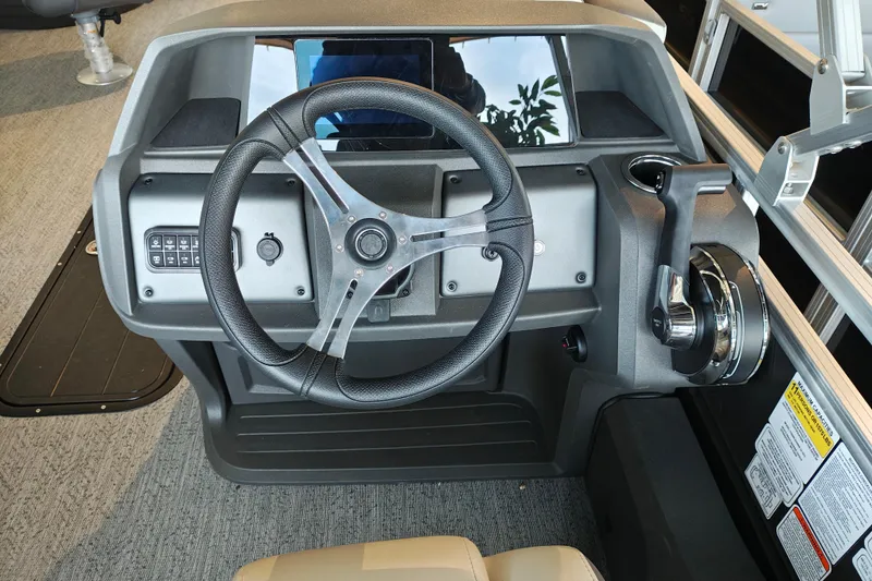 Slide: The Image of Steering console of 2026 Sun Tracker Fishin' Barge 22 XP3, featuring modern controls and design. - 106