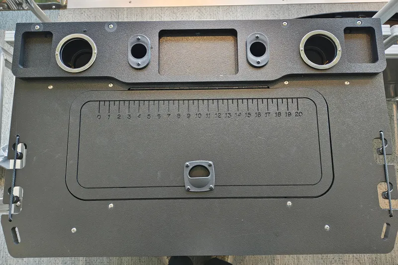 Slide: The Image of Control panel of 2026 Sun Tracker Fishin' Barge 22 XP3 with cup holders and measurement markings. - 108