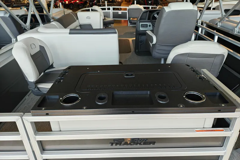 Slide: The Image of 2026 Sun Tracker Fishin' Barge 22 XP3 interior with seating and control panel. - 111
