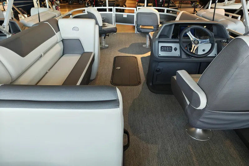 Slide: The Image of Interior of 2026 Sun Tracker Fishin' Barge 22 XP3, featuring spacious seating and modern helm. - 112