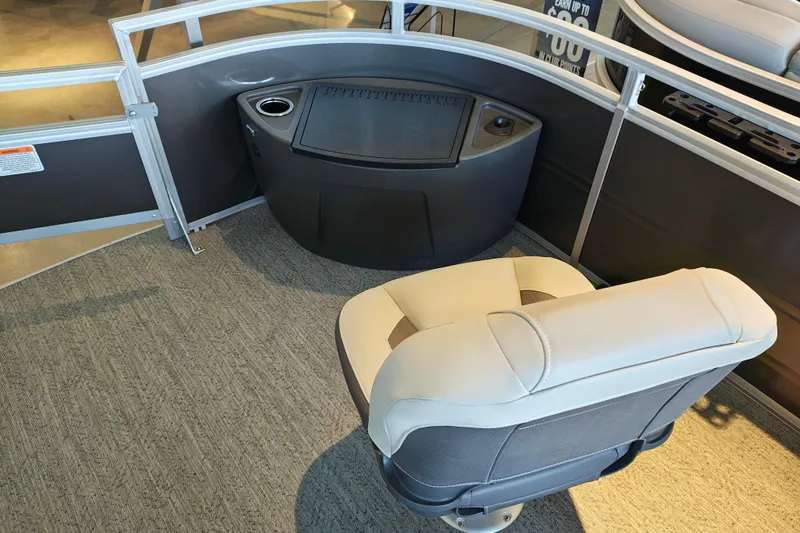 Slide: The Image of 2026 Sun Tracker Fishin' Barge 22 XP3 interior with seating and storage area. - 115