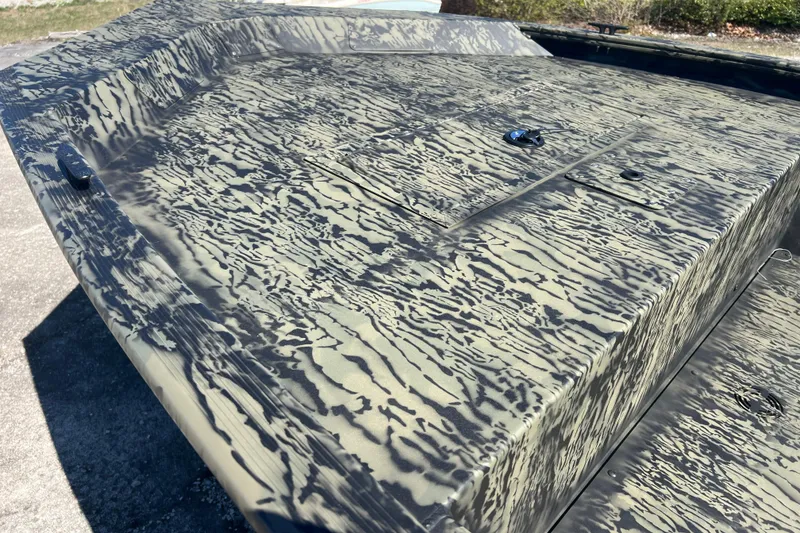 Slide: The Image of 2026 Tracker Grizzly 1648 Utility boat with camouflage pattern on deck. - 2