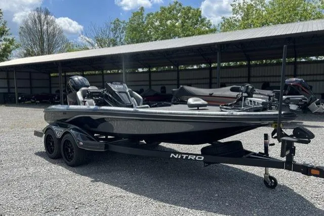 Slide: The Image of 2026 Nitro Z18 boat on trailer, parked outdoors under a clear sky. - 100