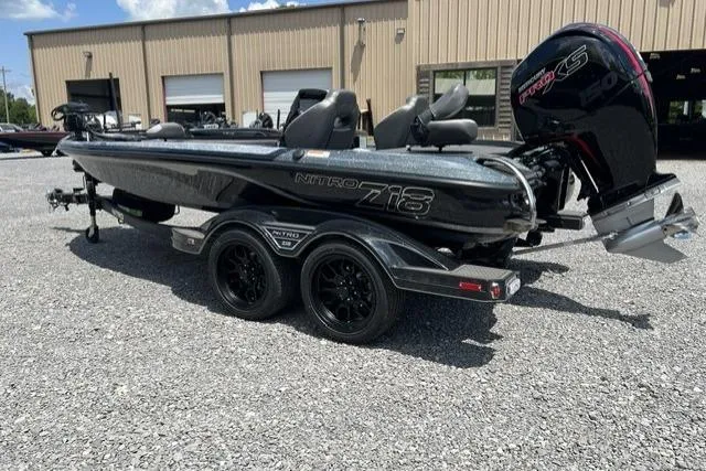 Slide: The Image of 2026 Nitro Z18 boat with dual axle trailer, parked outdoors on gravel. - 98