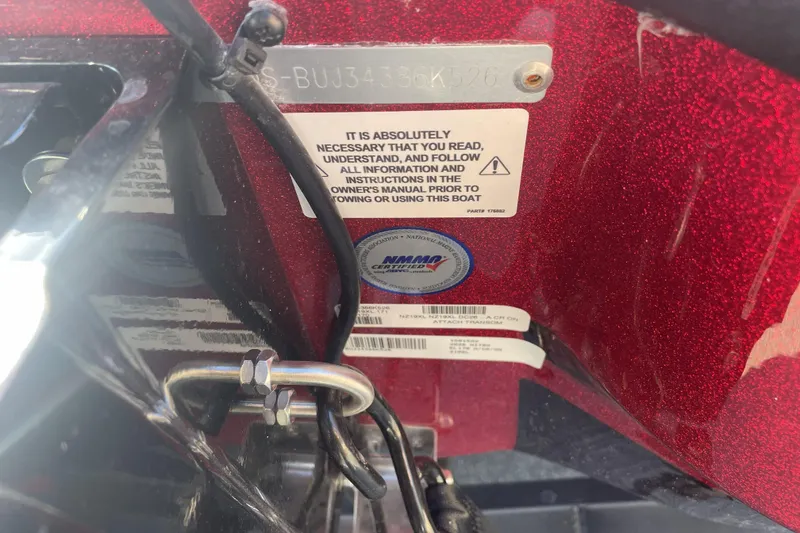 Slide: The Image of 2026 Nitro Z19 XL boat compliance and safety labels on red metallic surface. - 111