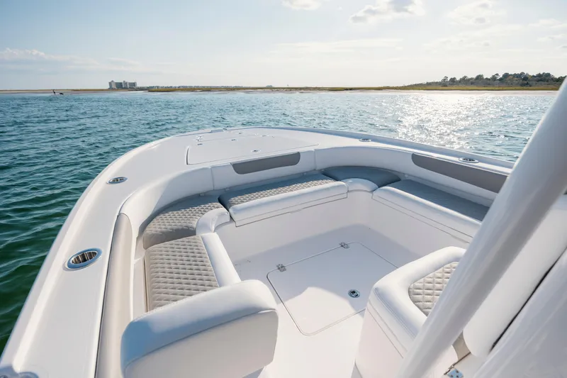 Slide: The Image of Caymas 26 HB 2026 boat on calm water with sunny sky. - 10