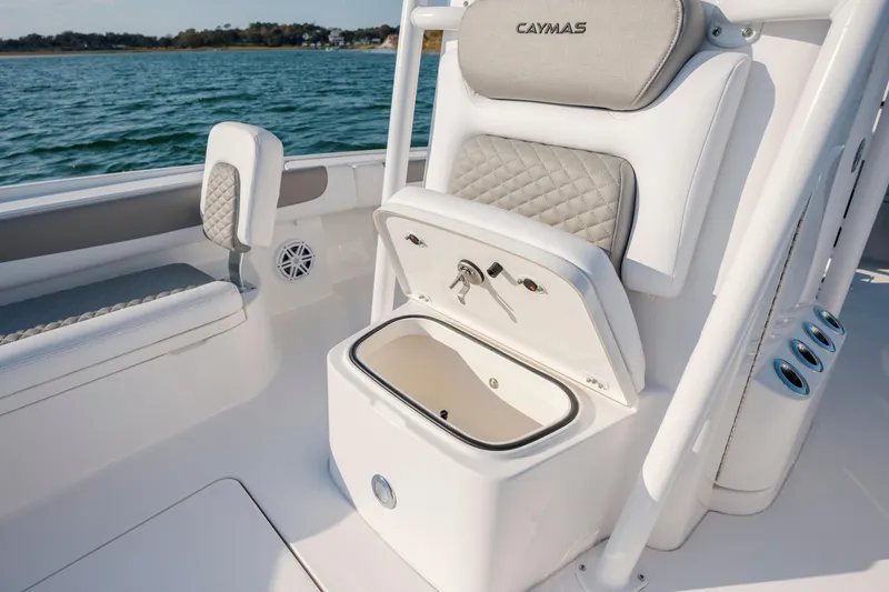 Slide: The Image of Caymas 26 HB 2026 boat with open storage compartment on water. - 16