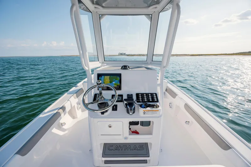 Slide: The Image of Caymas 26 HB 2026 boat on open water with helm console. - 18