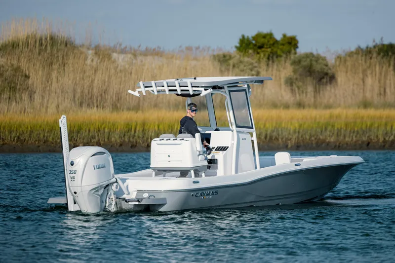 Slide: The Image of 2026 Caymas 26 HB boat on calm water. - 2