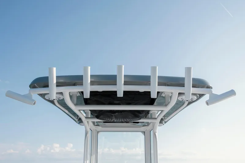 Slide: The Image of Caymas 26 HB 2026 boat roof with rod holders against blue sky. - 26