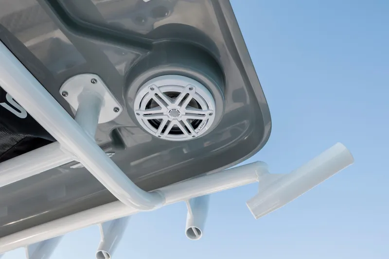 Slide: The Image of Speaker on Caymas 26 HB boat, 2026 model, against blue sky. - 27