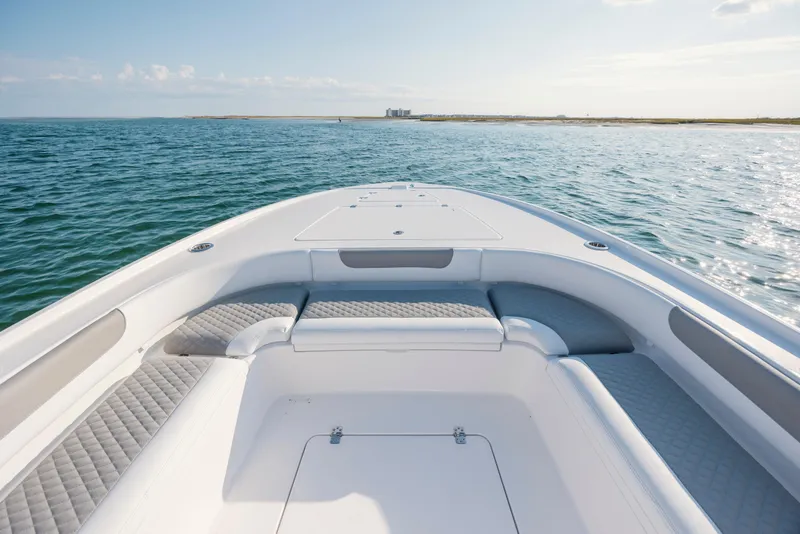 Slide: The Image of Caymas 26 HB 2026 boat on calm sea with sunny sky. - 9