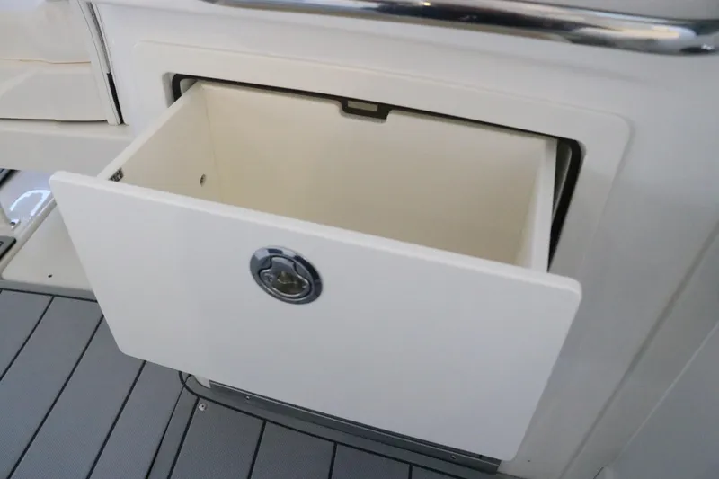 Slide: The Image of Interior of 2026 Chaparral 280 OSX boat with helm, seating, and sink. - 25