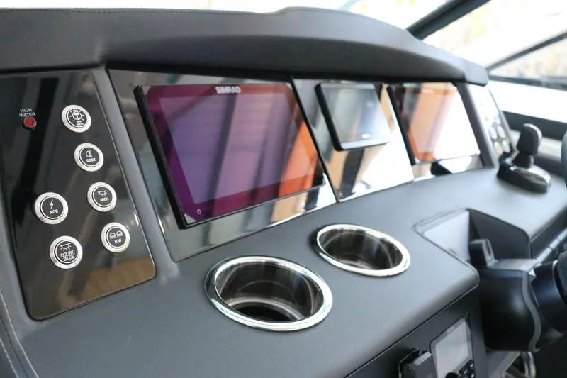 Slide: The Image of Dashboard of 2026 Chaparral 280 OSX with Simrad displays and cup holders. - 29