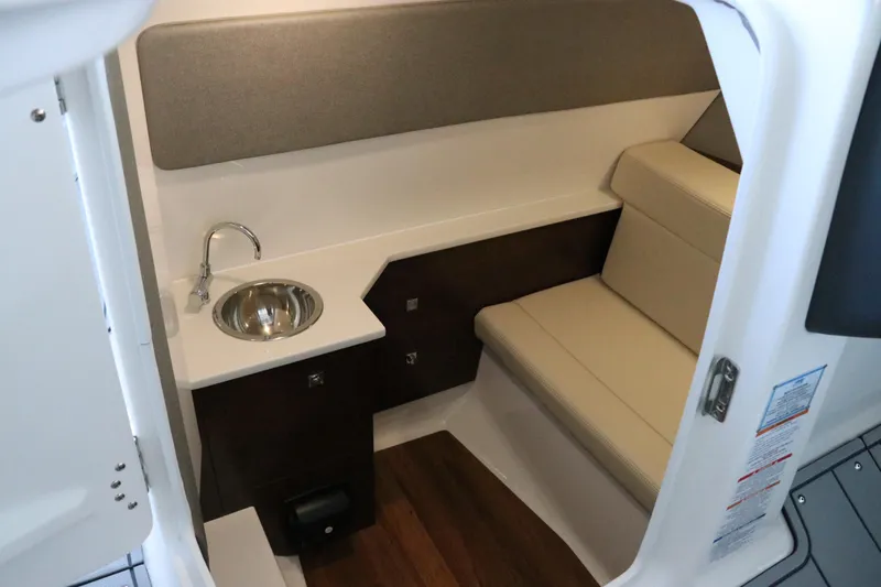 Slide: The Image of 2026 Chaparral 280 OSX boat interior with sink and storage cabinet. - 40