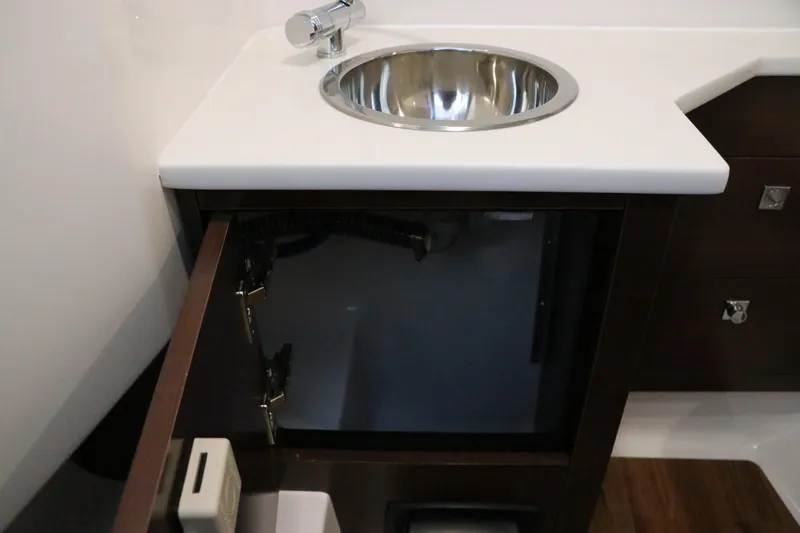 Slide: The Image of Open storage compartment in 2026 Chaparral 280 OSX boat interior. - 42