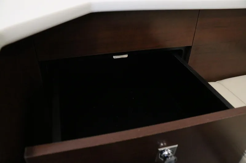 Slide: The Image of Interior cabin of 2026 Chaparral 280 OSX boat with cushioned seating and porthole window. - 44