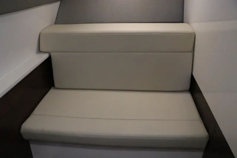 Slide: The Image of 2026 Chaparral 280 OSX boat interior with compact toilet in wooden cabinet. - 47