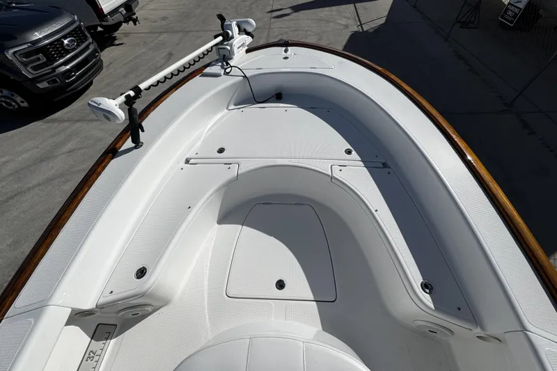 Slide: The Image of 2018 Chaos 21 Tarpon Bay boat bow with open hatch and trolling motor. - 10