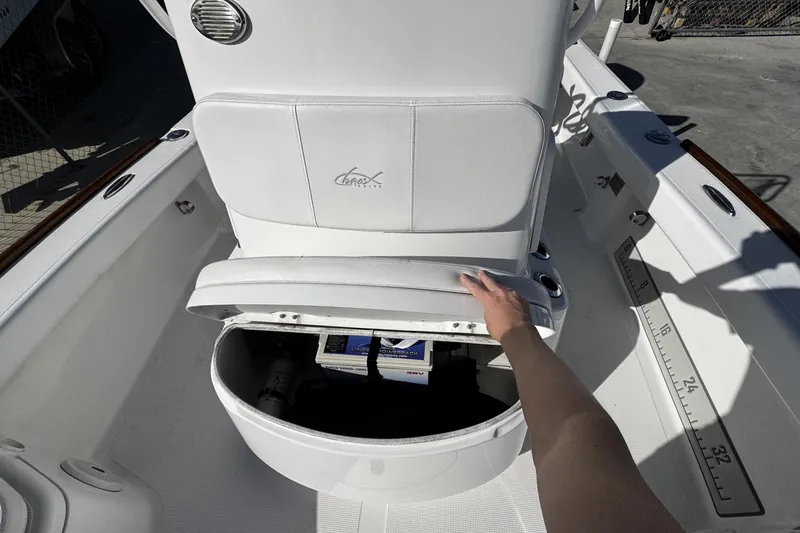 Slide: The Image of 2018 Chaos 21 Tarpon Bay boat interior with seating and console, docked among other boats. - 15