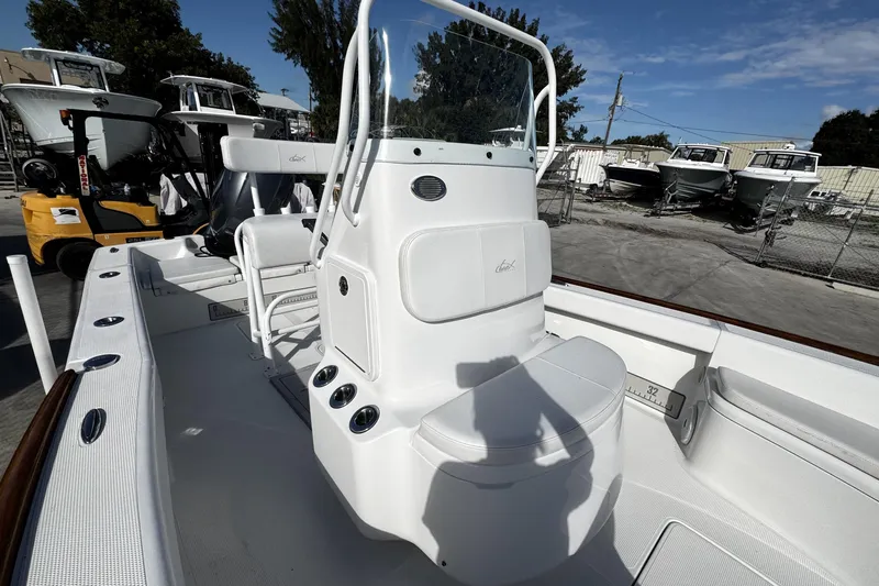 Slide: The Image of 2018 Chaos 21 Tarpon Bay boat interior with Garmin navigation system and steering wheel. - 18