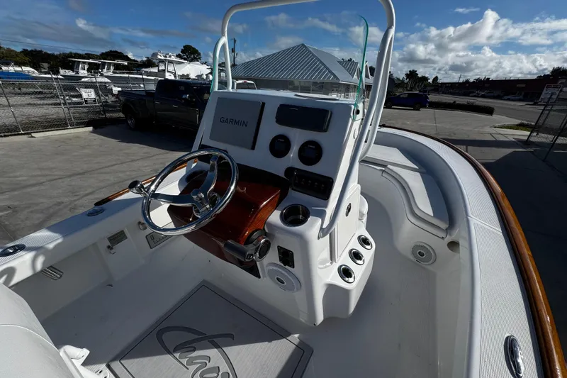 Slide: The Image of 2018 Chaos 21 Tarpon Bay boat dashboard with steering wheel and controls. - 20
