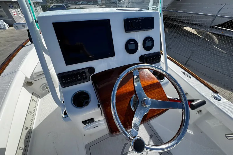 Slide: The Image of 2018 Chaos 21 Tarpon Bay boat interior with control panel and speakers. - 23