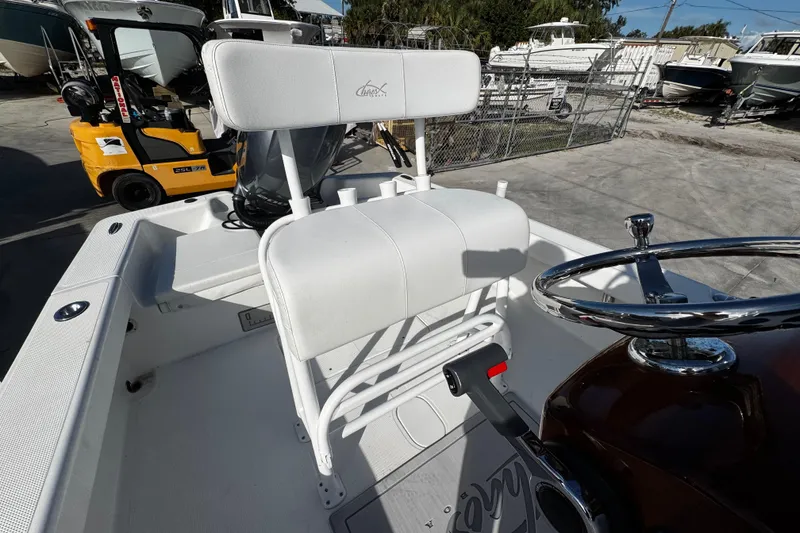 Slide: The Image of 2018 Chaos 21 Tarpon Bay boat interior with open storage compartment and seating. - 26