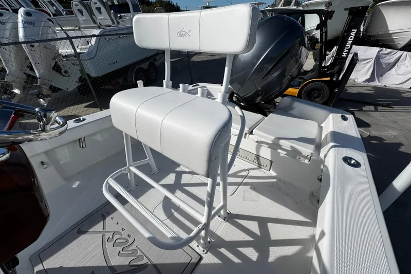 Slide: The Image of 2018 Chaos 21 Tarpon Bay boat with outboard motor, docked in a marina. - 27