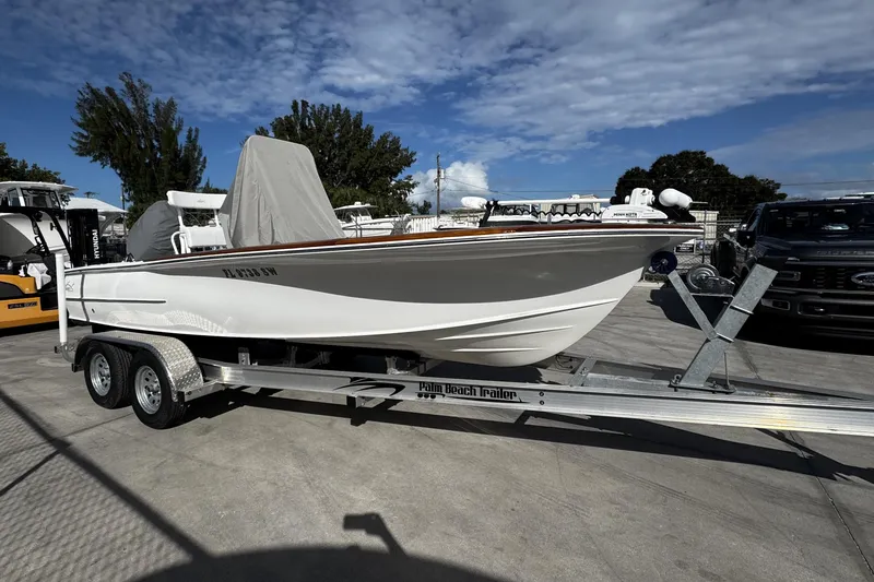 Slide: The Image of 2018 Chaos 21 Tarpon Bay boat on trailer under blue sky. - 5