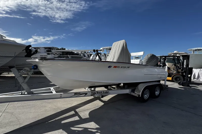 Slide: The Image of 2018 Chaos 21 Tarpon Bay boat on trailer under clear blue sky. - 6