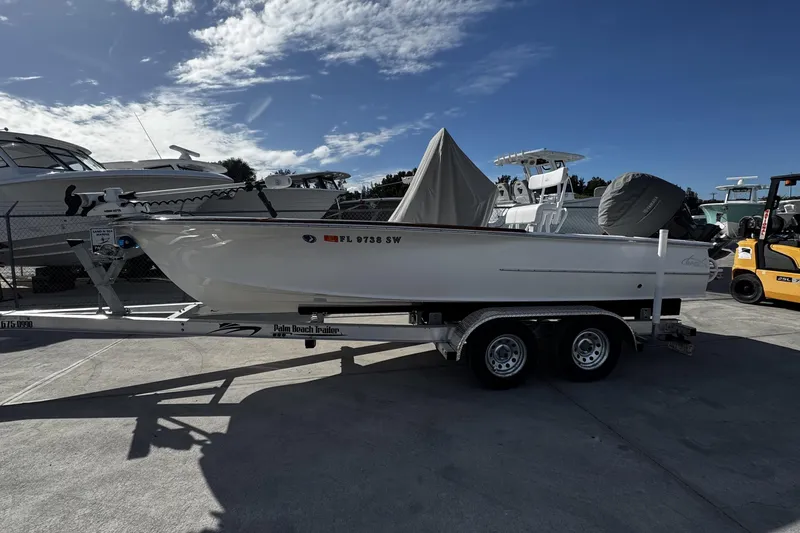 Slide: The Image of 2018 Chaos 21 Tarpon Bay boat on trailer under clear blue sky. - 7