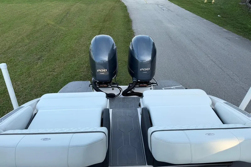 Slide: The Image of 2021 Regal 29 OBX boat with twin 200 horsepower outboard engines, rear seating view. - 14