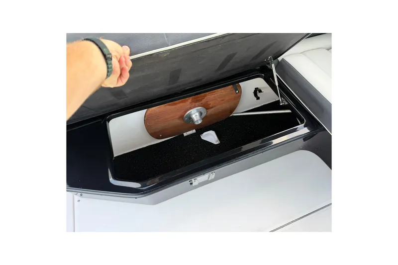 Slide: The Image of 2021 Regal 29 OBX boat storage compartment with open lid, showcasing interior space. - 18