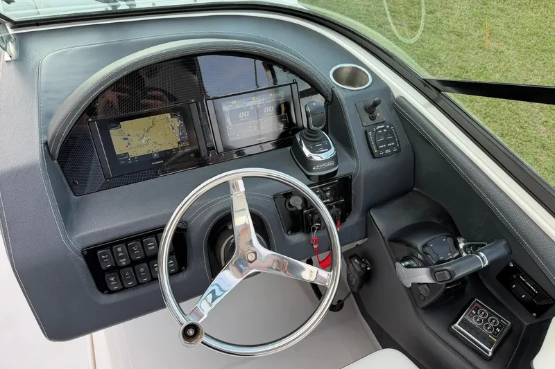 Slide: The Image of 2021 Regal 29 OBX boat dashboard with steering wheel and navigation displays. - 21