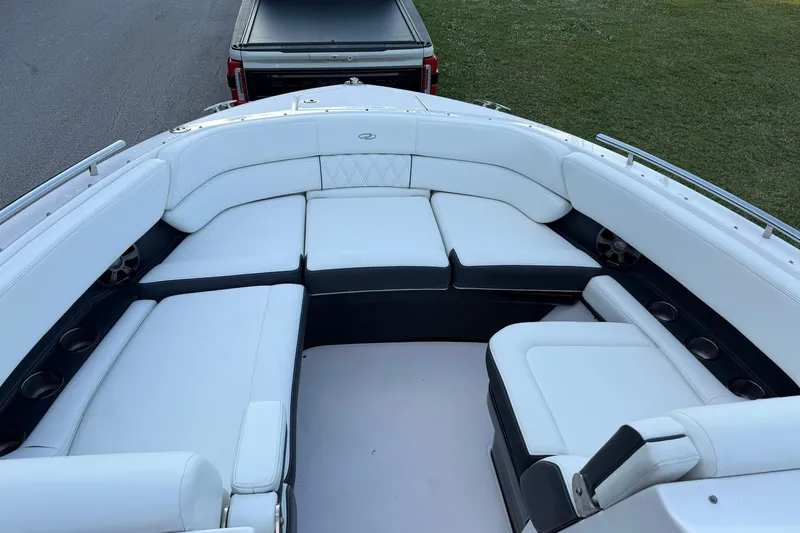 Slide: The Image of 2021 Regal 29 OBX boat with spacious white seating and cup holders. - 23