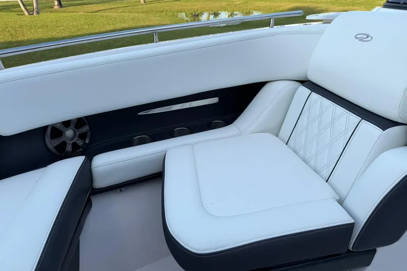 Slide: The Image of 2021 Regal 29 OBX boat interior with white leather seating and speaker. - 25