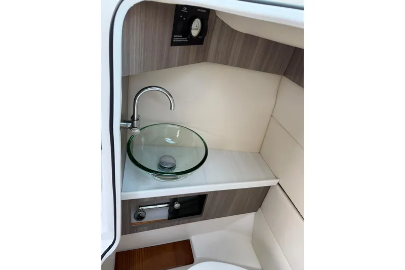 Slide: The Image of 2021 Regal 29 OBX boat interior with modern glass sink and faucet. - 30